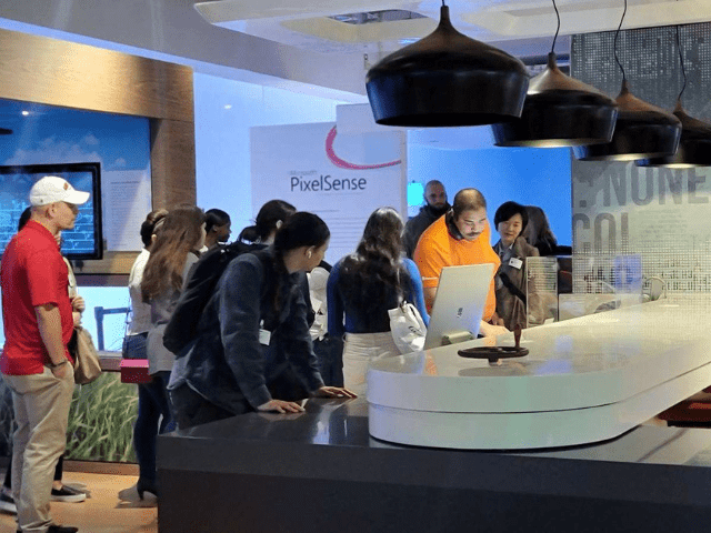 Students examine computers at Microsoft