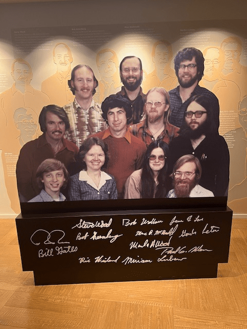 Cardboard cutout of the Microsoft founders when young, with their signatures below