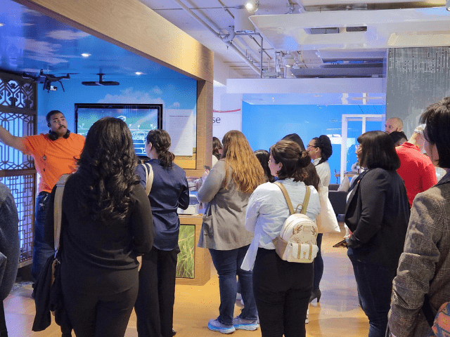 Students listen to a guide on Microsoft tour