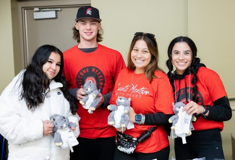 New students and their mentor hold stuffed animals