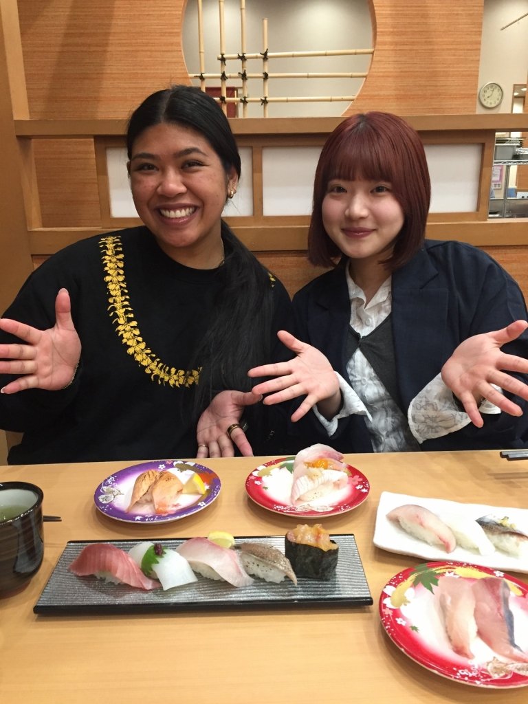 Students show off their meal of fish