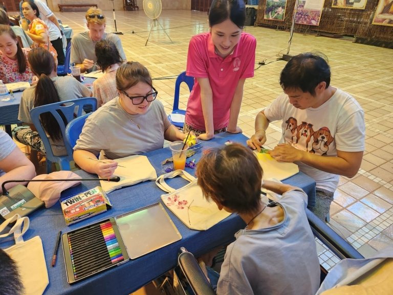 Students work with children on art therapy in Thailand