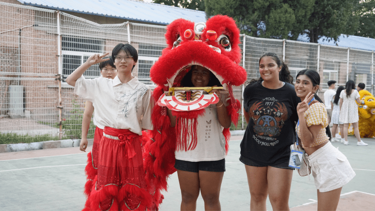 A group of students in red lion costume