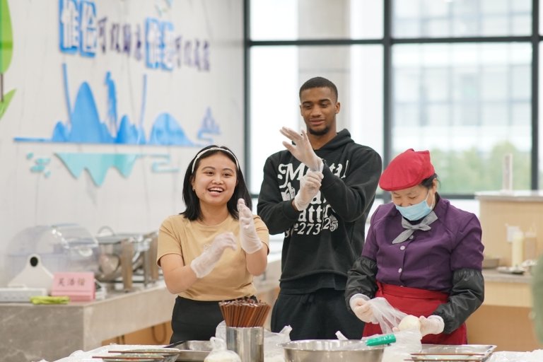 Students put on gloves in kitchen