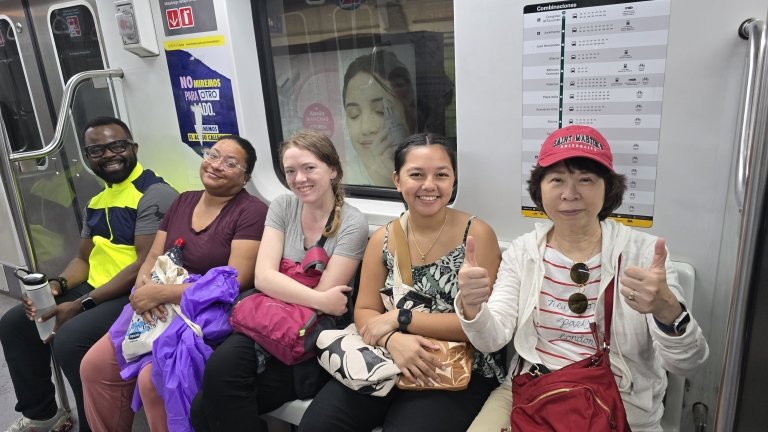 Students and faculty sit on a subway