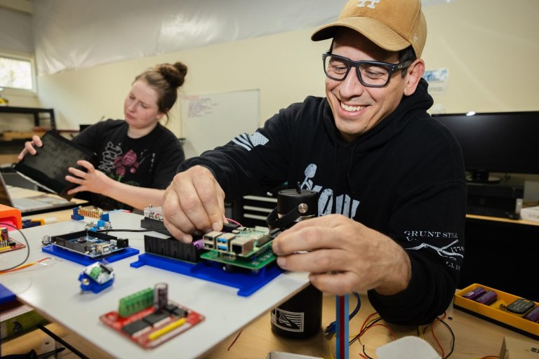 Students work with technical components