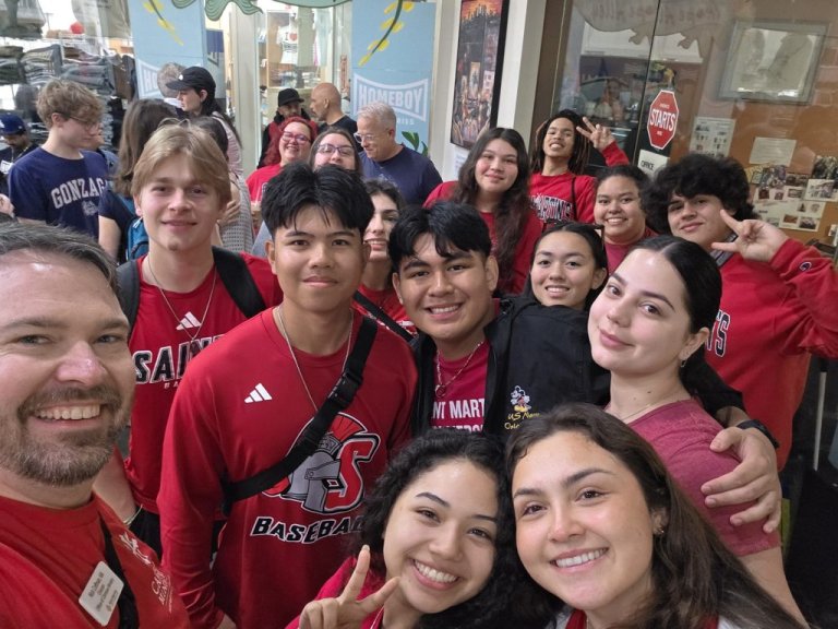 Students in red shirts pose at Homeboy Industries