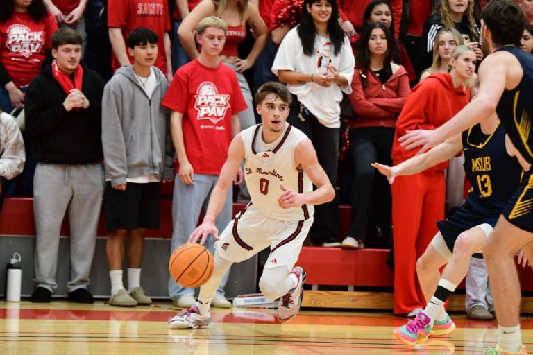 A Saints basketball player dribbles the ball during a game