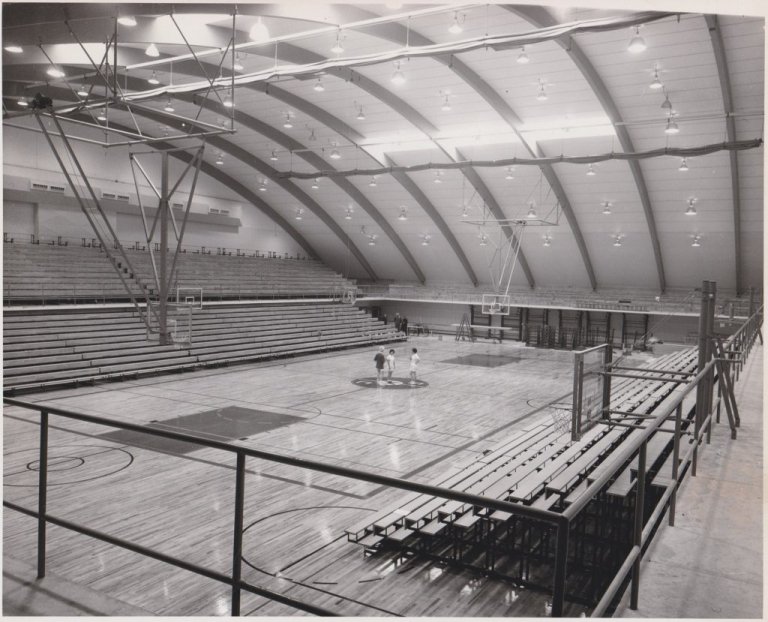Marcus Pavilion basketball court with a couple players in the middle, in black and white