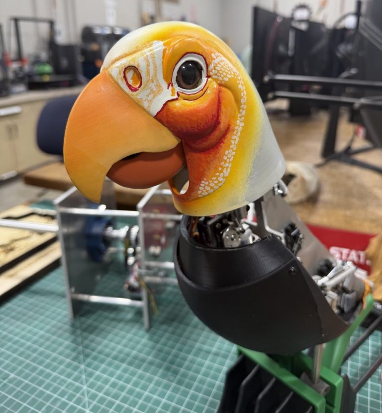 An animatronic parrot on a desk