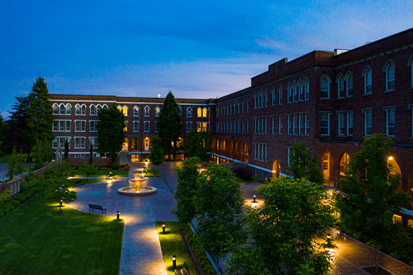 Old Main and the courtyard lit up at night