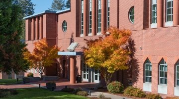 Facade of O'Grady Library with trees in autumn colors.