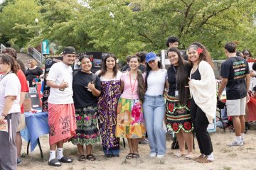 Students in a club pose at involvement fair